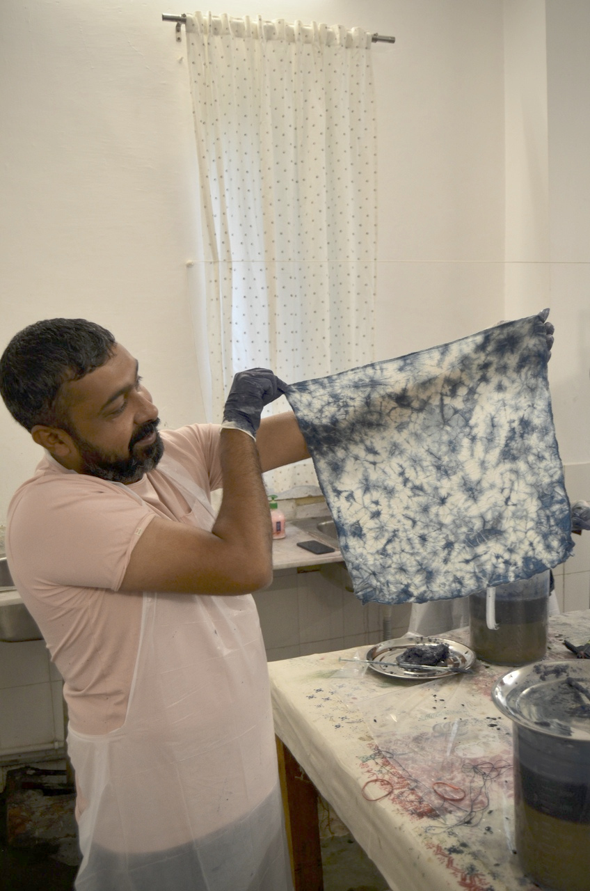 A man holding his indigo dipped tie and die swatch