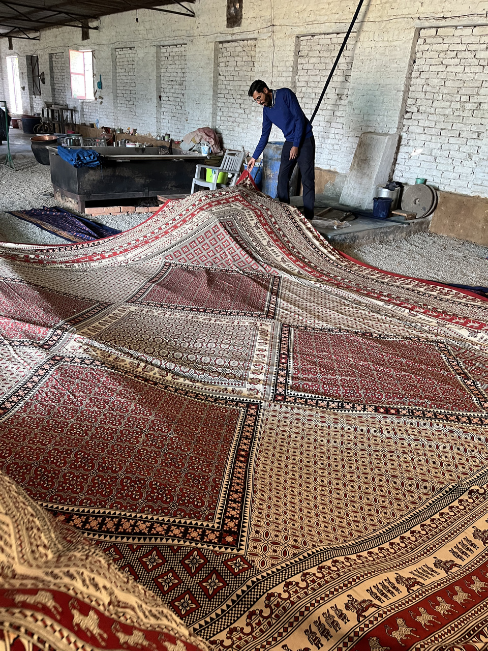 Laying the long piece of block printed fabric on the floor